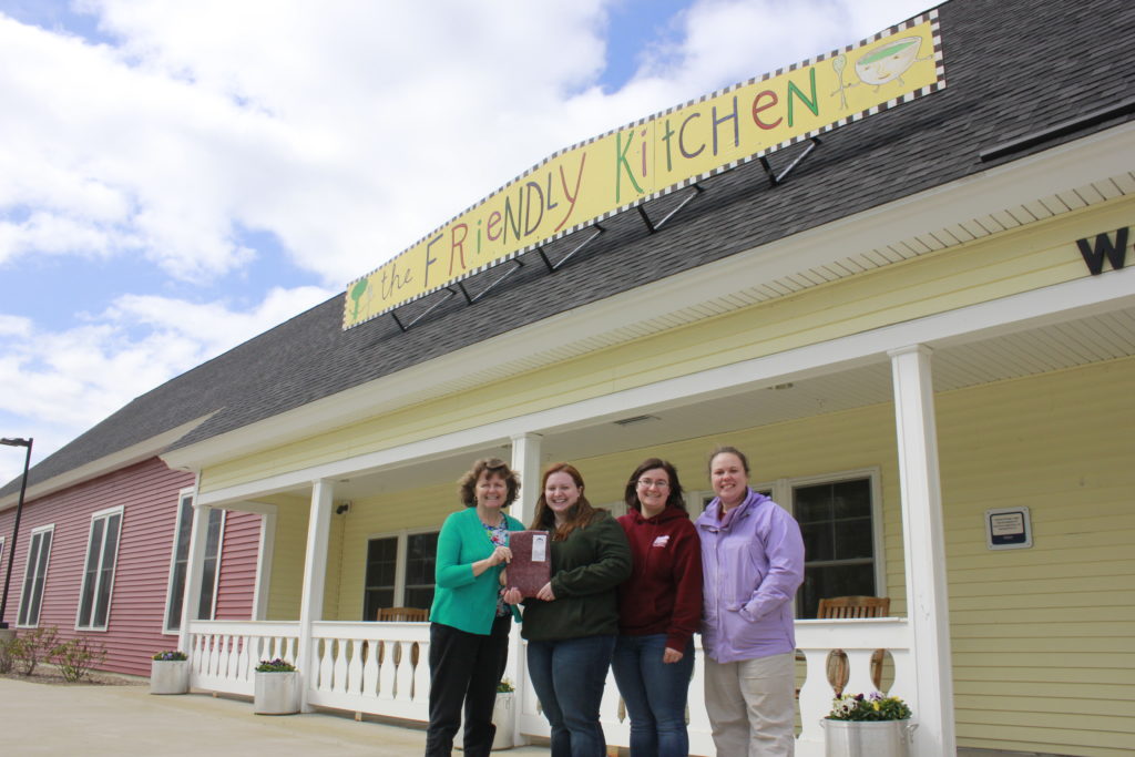 (left to right) Friendly Kitchen Director Jennifer Lombardo, Young Farmer Committee Chair Amy Matarozzo, Young Farmer Coordinator Leandra Pritchard, and Young Farmer Committe Vice-Chair Christina Murdock at the Friendly Kitchen in Concord, NH. 